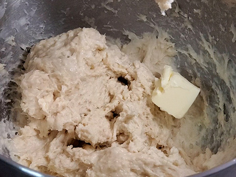 Adding butter while kneading dough in stand mixer