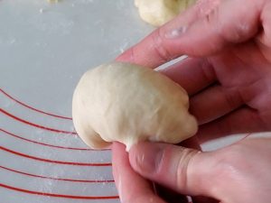 Shaping dough into round ball