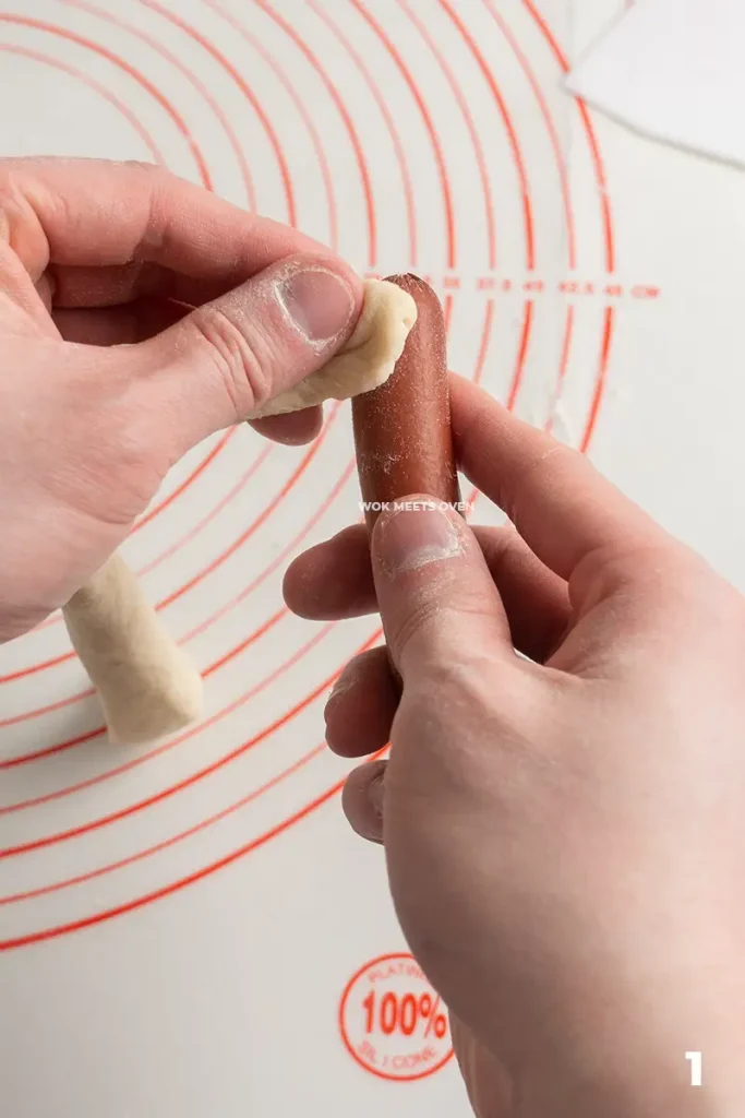 Wrapping the dough onto hotdog step 1