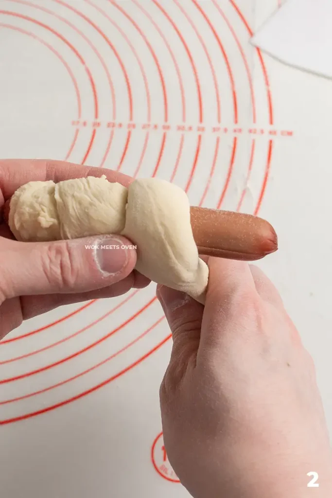 Wrapping the dough onto hotdog step 2