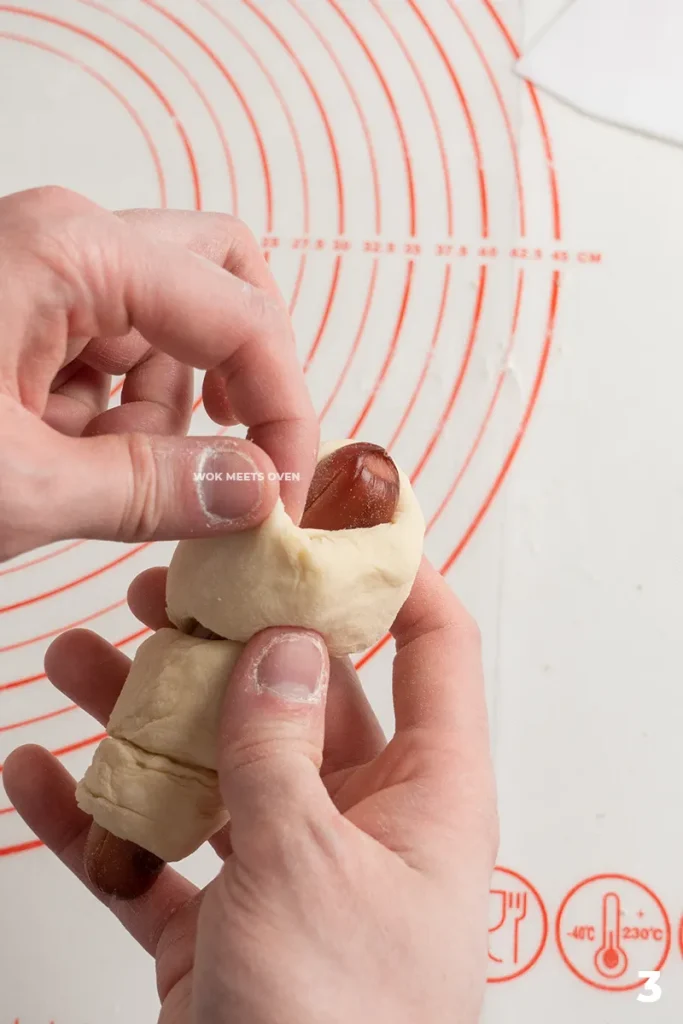 Wrapping the dough onto hotdog step 3