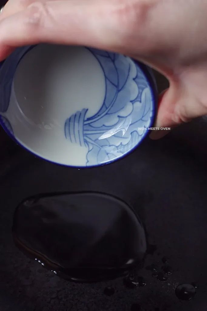 Adding in oil to wok