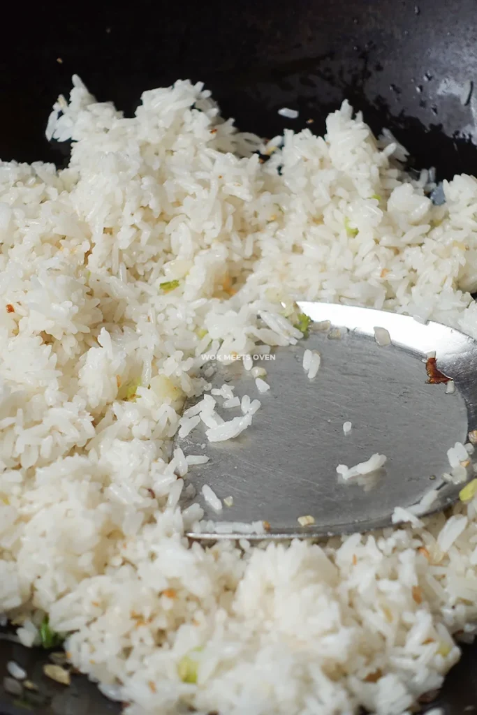 Pressing down onto rice with spatula