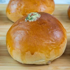Finished baked tuna buns on wooden cutting board