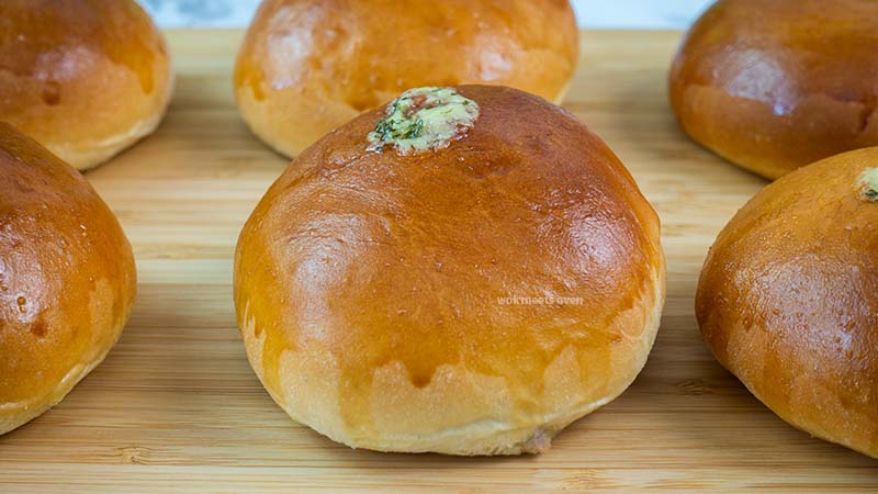 Finished baked tuna buns on wooden cutting board