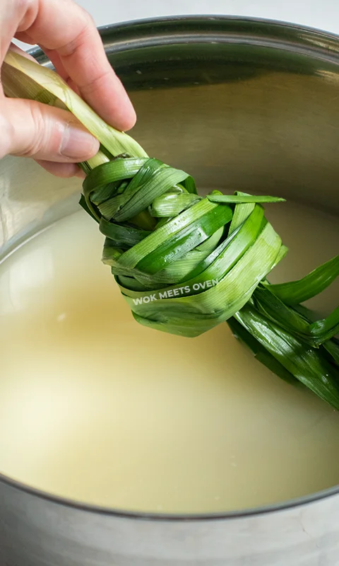 Adding in pandan leaves into pot
