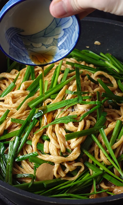 Adding in sesame oil to wok