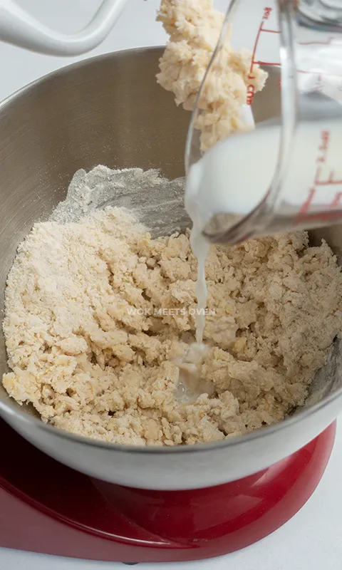 Adding in milk to mixing bowl