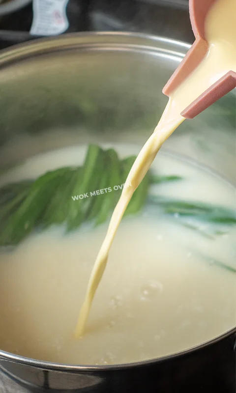 pouring in blended kernels and milk into pot