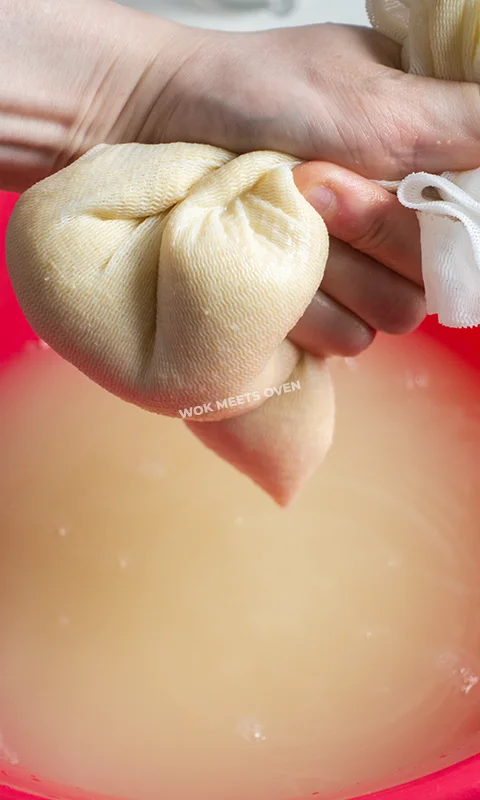 Squeezing out excess liquid from cheese cloth bag