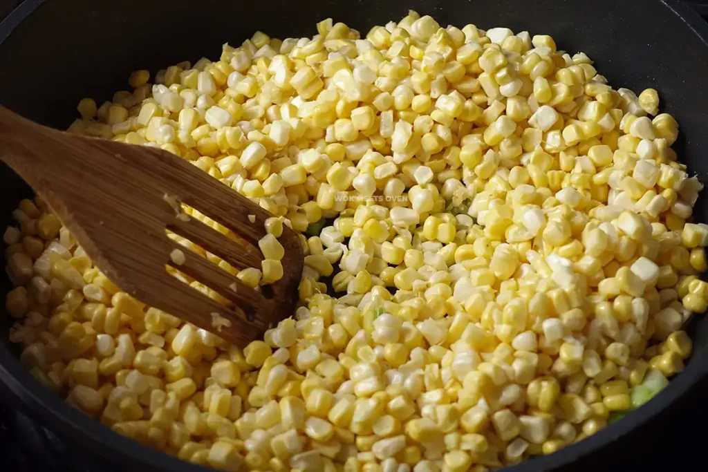 Adding in corn kernels to wok