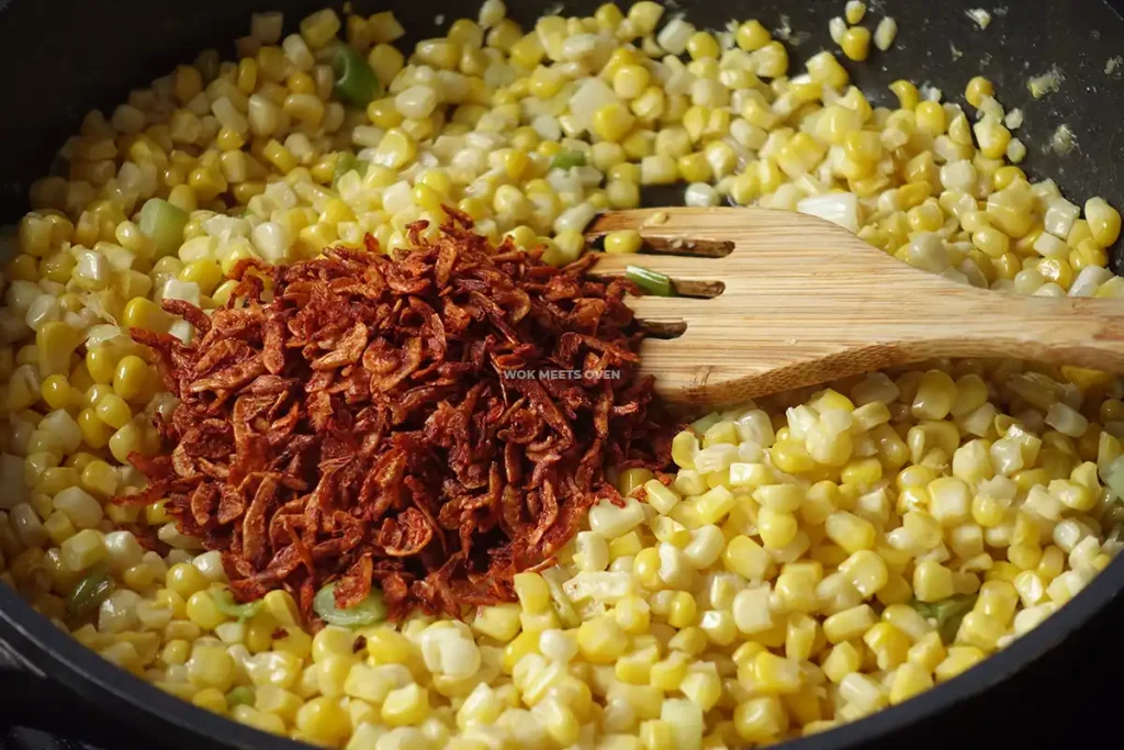 Adding in dried shrimp to corn kernels