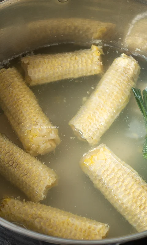 Boiling corn cobs with Pandan leaves in pot