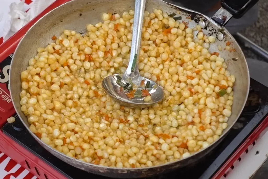 Street vender making stir-fried corn