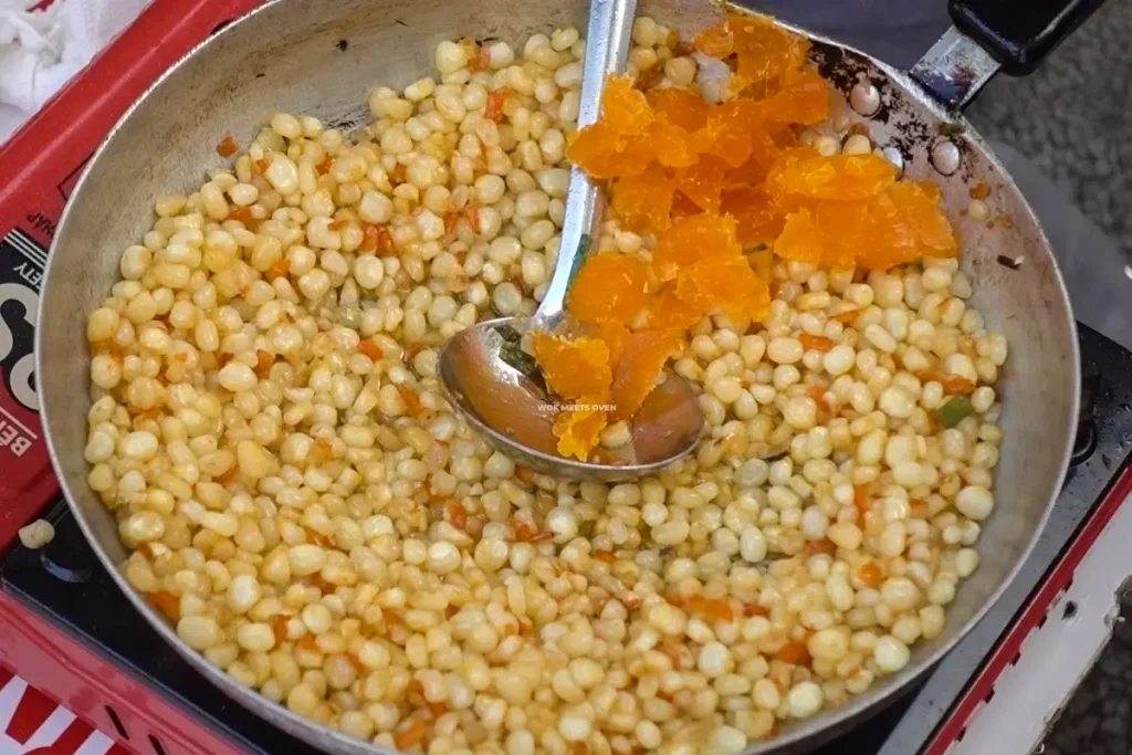 Adding in salted duck egg yolk to stir-fried corn