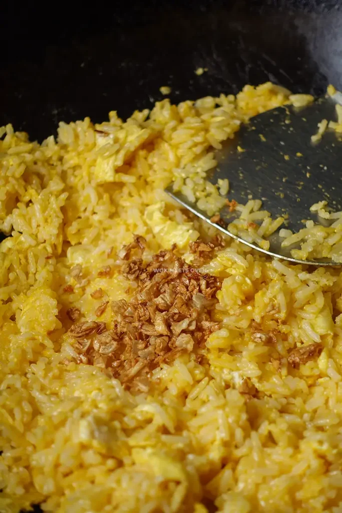 Adding in fried garlic to fried rice