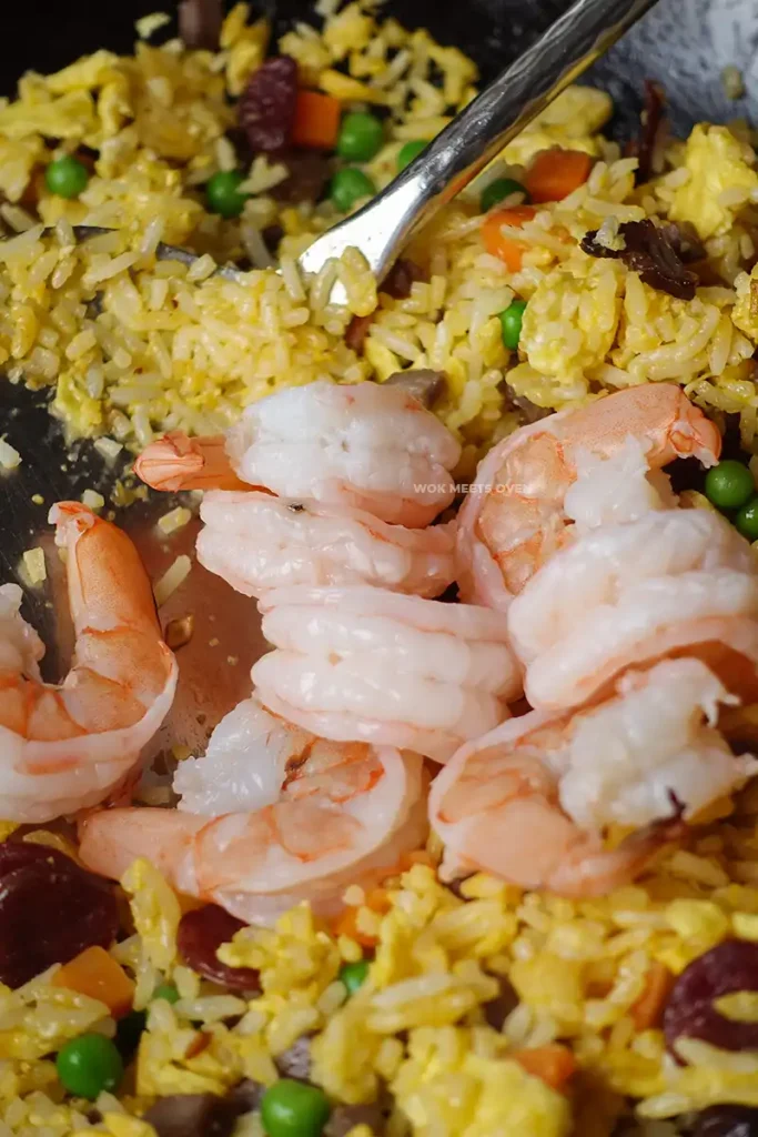 Adding in shrimp to fried rice
