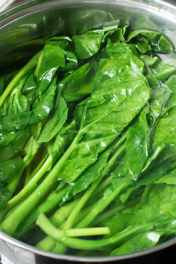 Blanching Gai Lan in pot of water