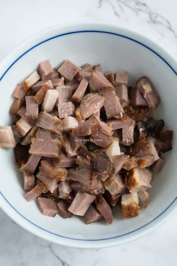 Cut char siu in bowl