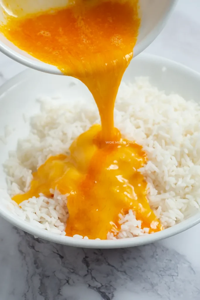 Pouring eggs onto rice