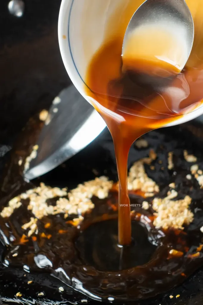 Pouring in sauce into wok