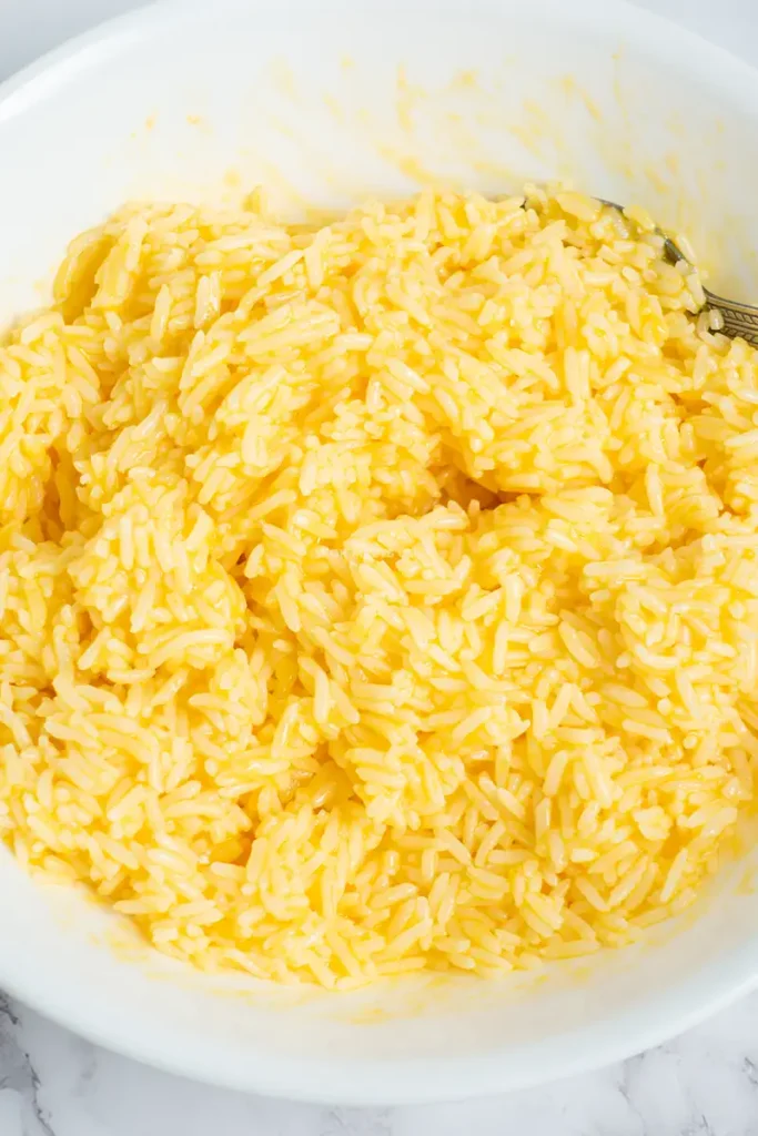 Bowl of mixed rice with eggs and annatto oil