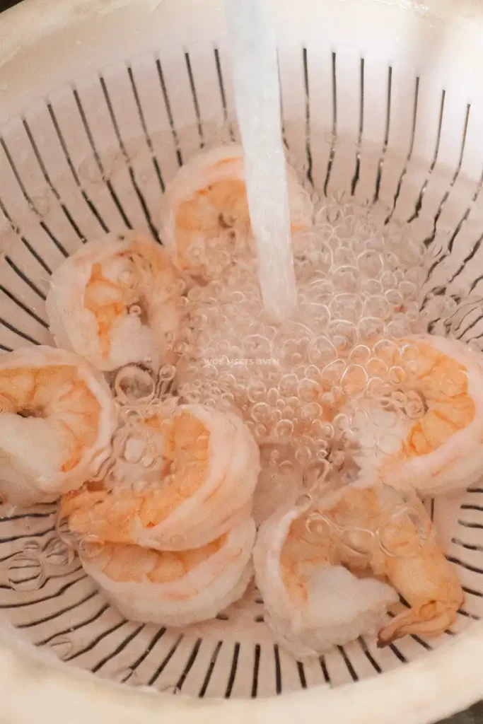 Running shrimp under cold water