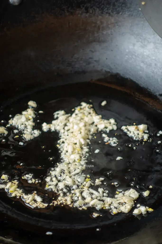 stir-frying onions on wok