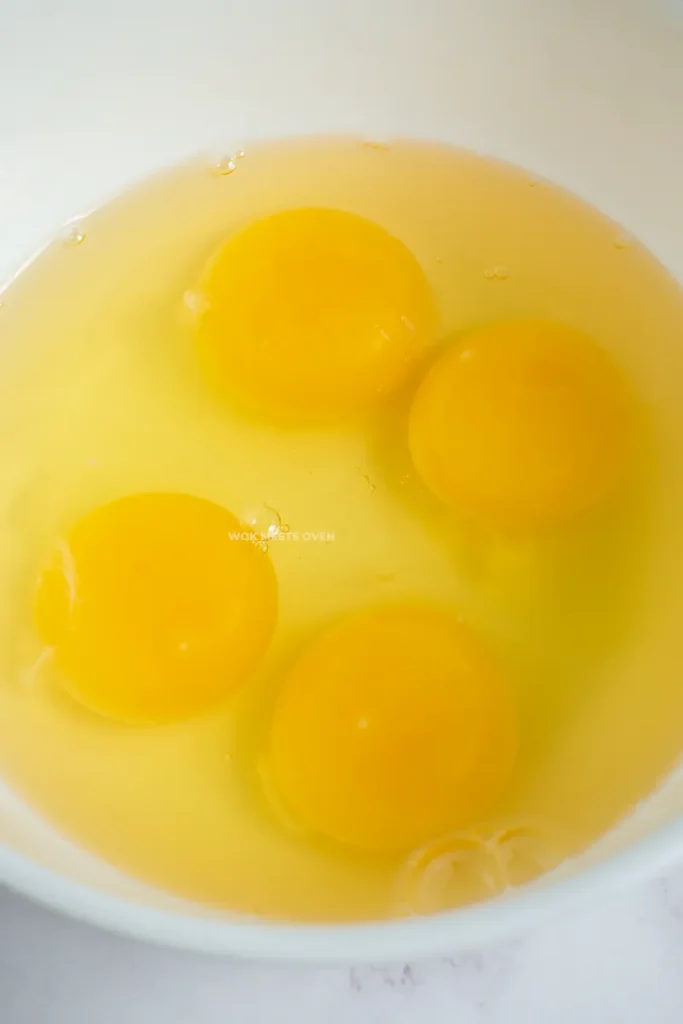 Cracked eggs in bowl