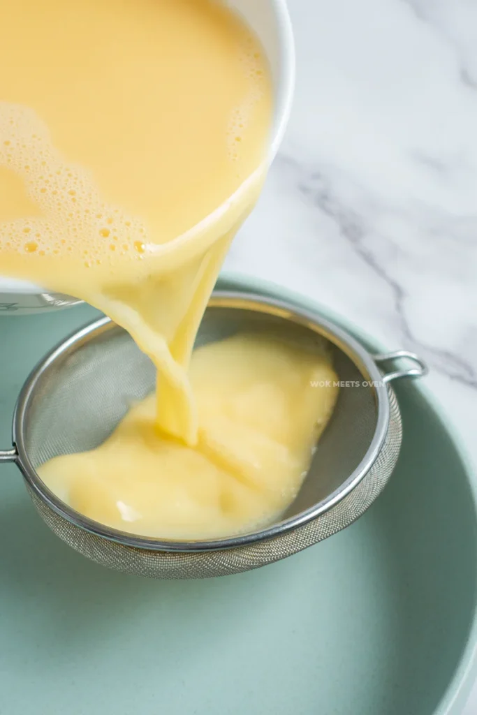pouring eggs through a sieve