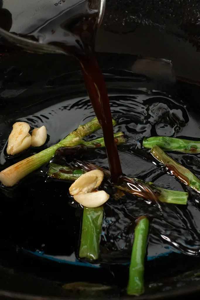 Adding in sauce to wok