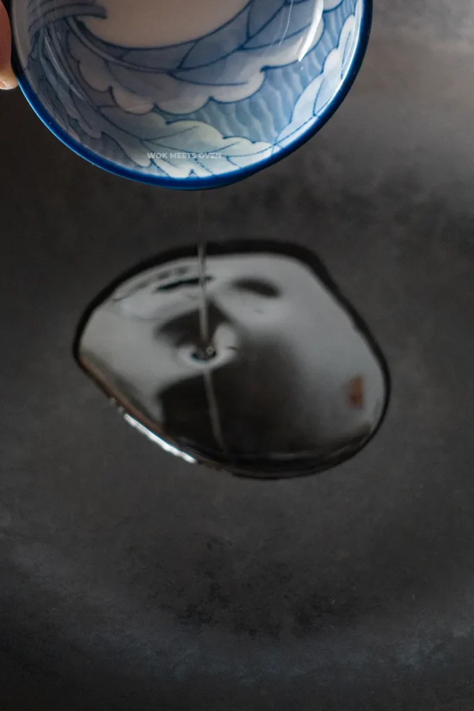 Adding in oil to wok