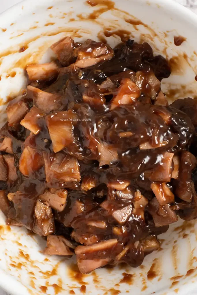 Mixing sauce with char siu