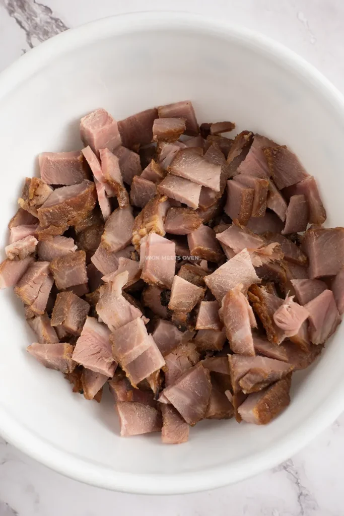 Cut char siu in bowl