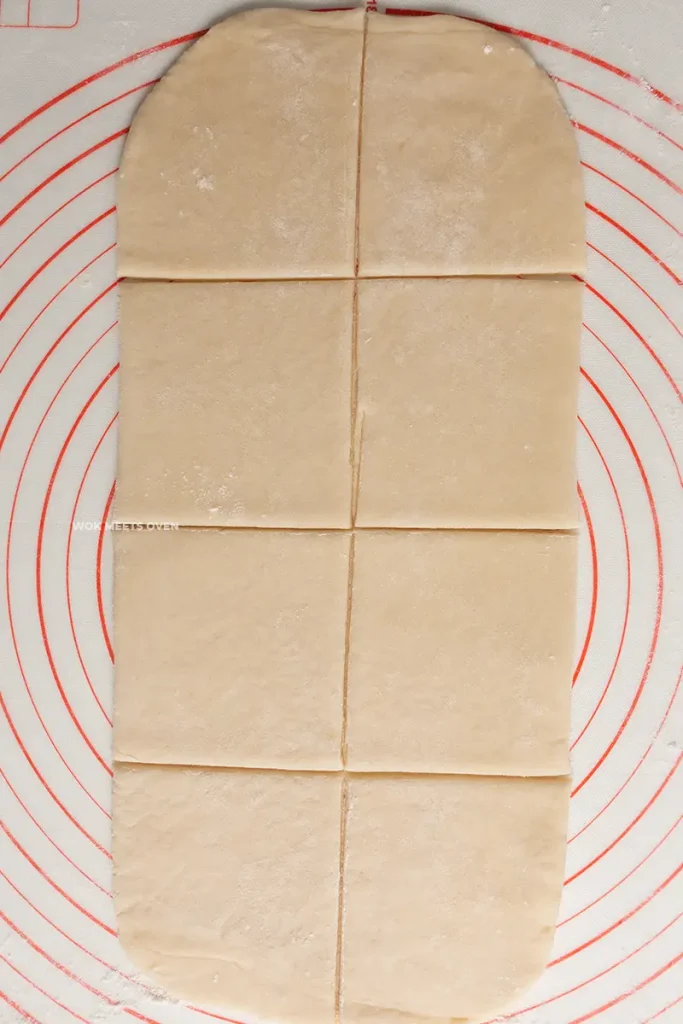 Cutting the puff pastry sheet into 8 pieces