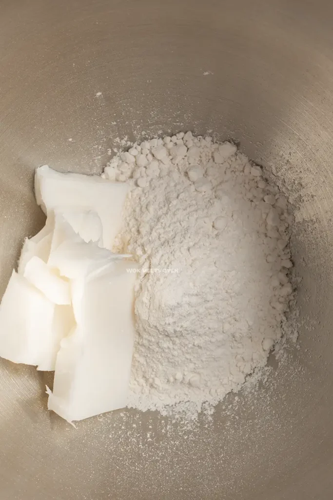 Adding in lard and flour in mixing bowl