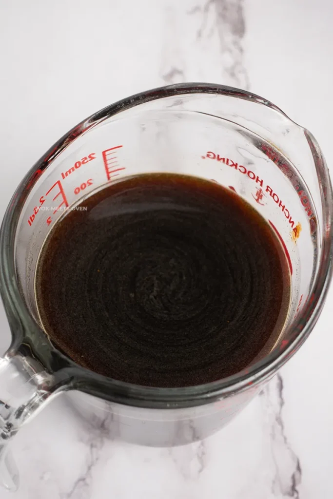 Prepared sauce in measuring cup