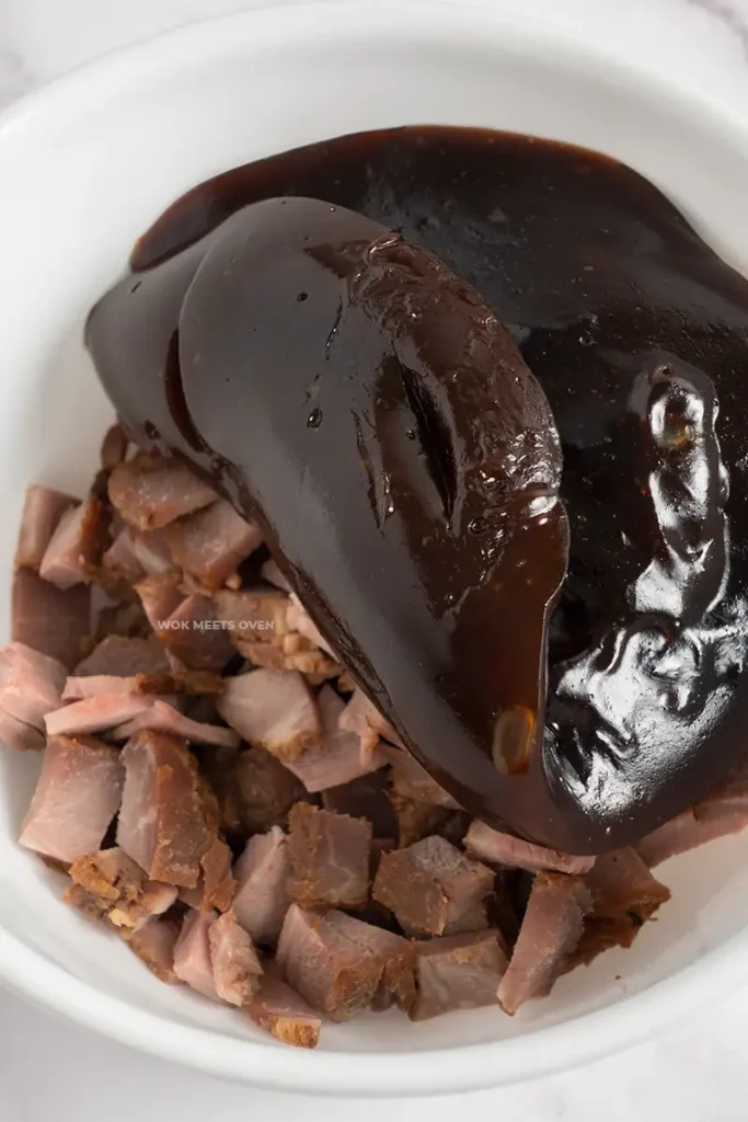 Adding in sauce to char siu