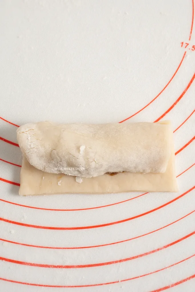 Wrapping puff pastry sheet over and under the filling