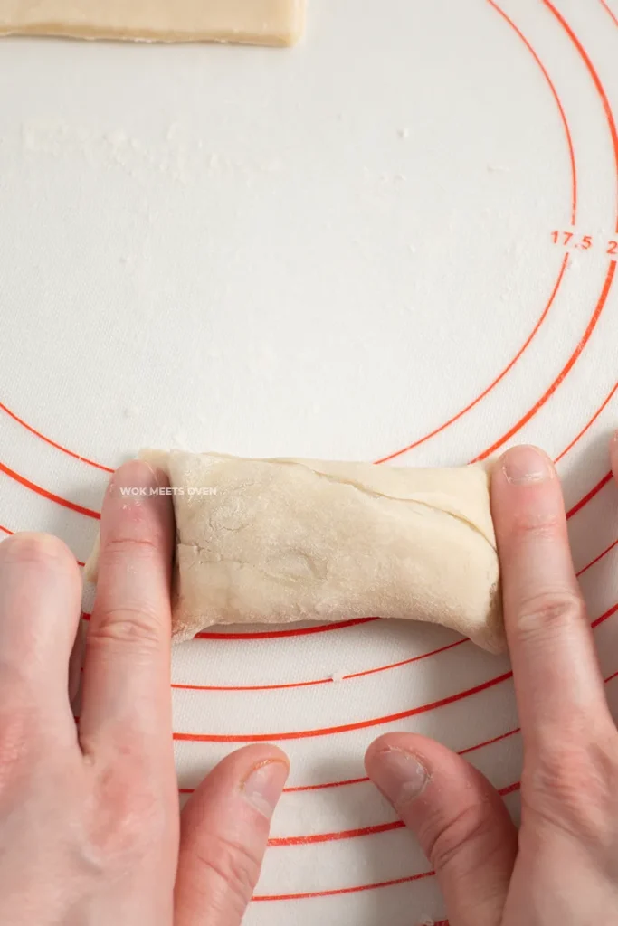 Pressing down on both sides of the puff pastry with index fingers