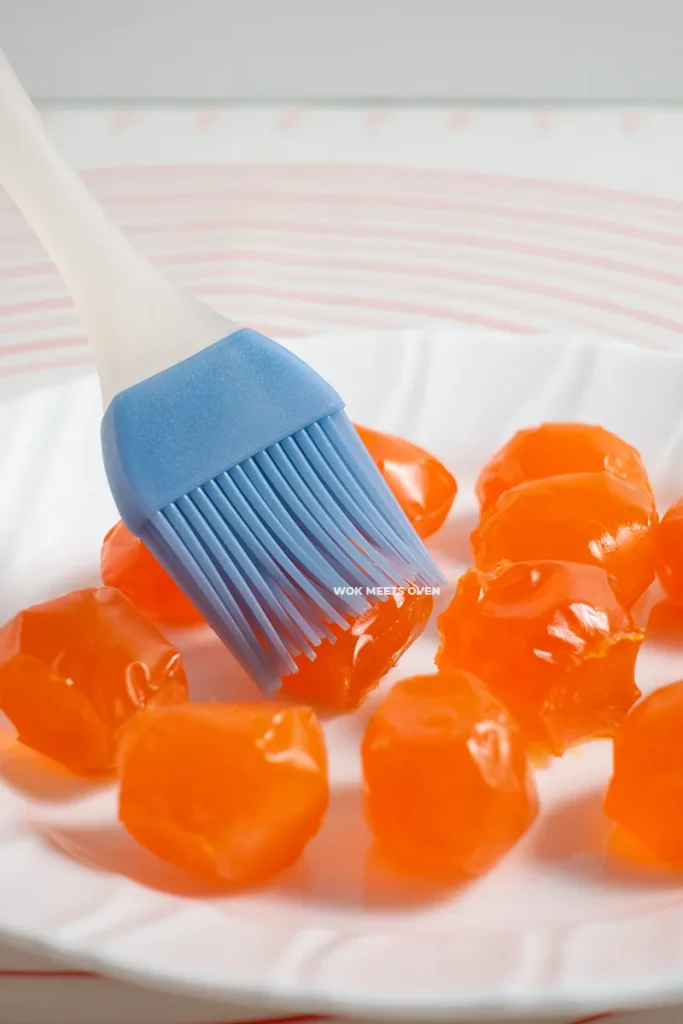 Brushing rose wine onto salted duck egg yolks