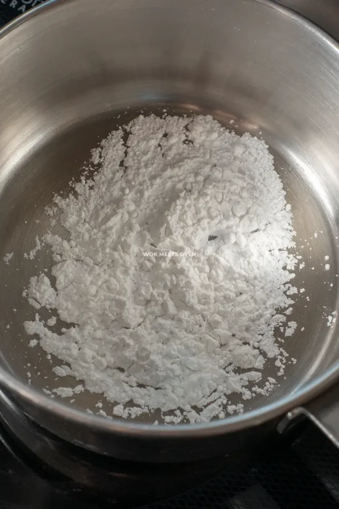 Adding glutinous rice flour to saucepan