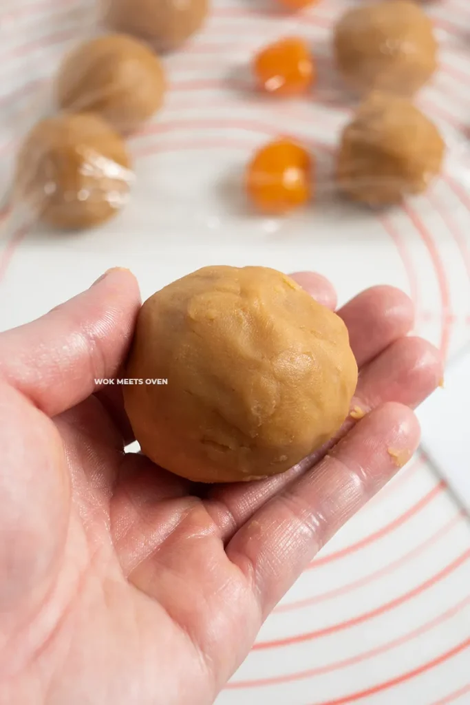 Finished wrapping lotus paste on top of egg yolk