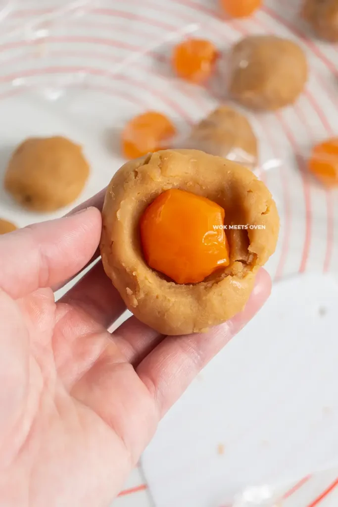 Adding in egg yolks to lotus paste hole