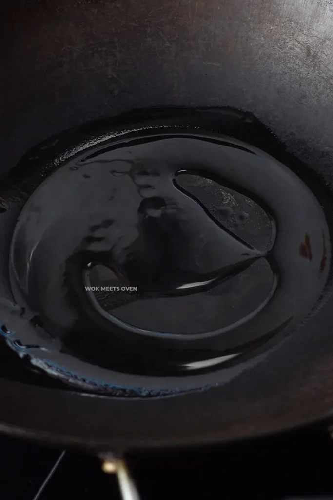 Adding oil to wok