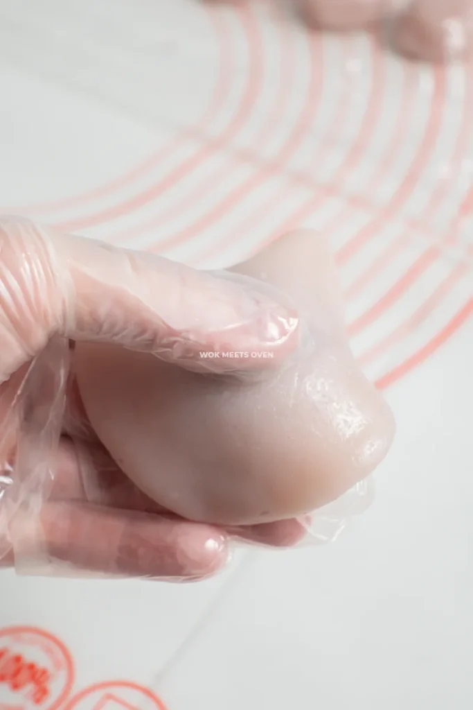 Flipping snow skin mooncake over during shaping process