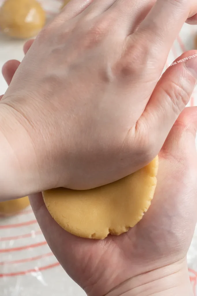 Picture demonstrating using palm to flatten dough