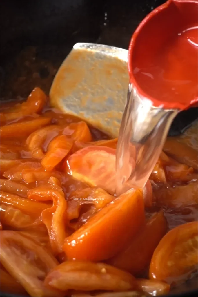 Adding in water to tomatoes