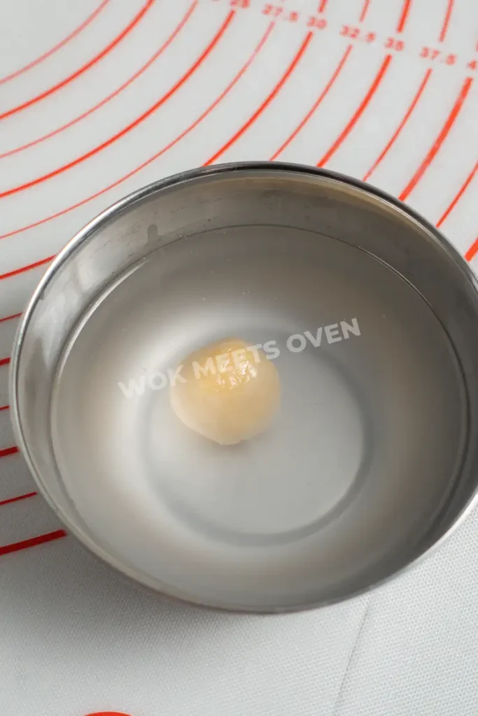 Dipping dough balls in water