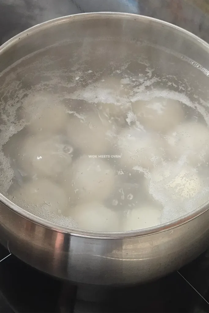 Adding tang yuan to pot of water